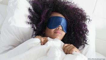mujer durmiendo con luz y los ojos tapados