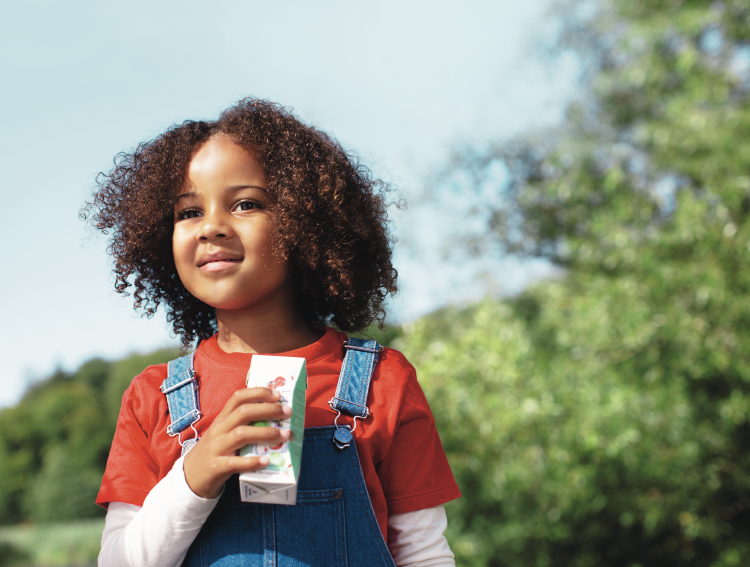 Little Girl holding carton girl holding carton