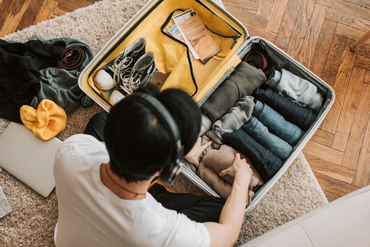 Persona preparando su maleta de viaje