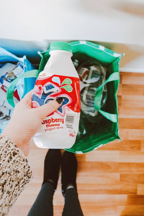 person holding red and white disposable bottle 1933386