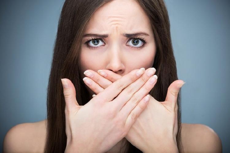 mujer cubre sus dientes mujer cubre sus dientes