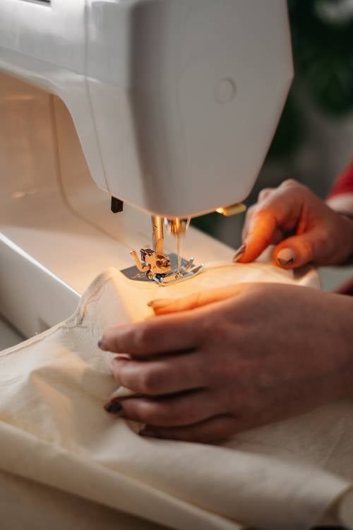 person using a sewing machine 3738095