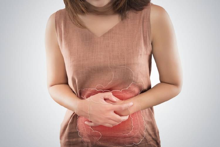 intestino inflamación Una mujer se sujeta el abdomen