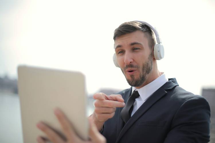 man in black suit jacket while wearing white headphones 3778844