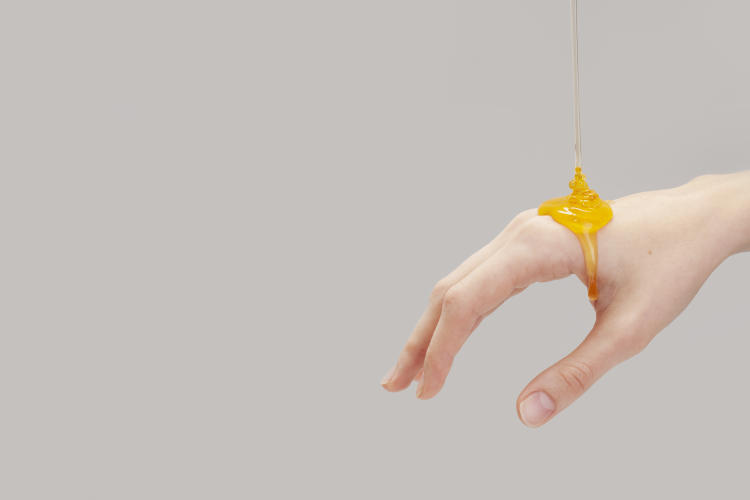 organic honey pouring on hand organic honey pouring on hand